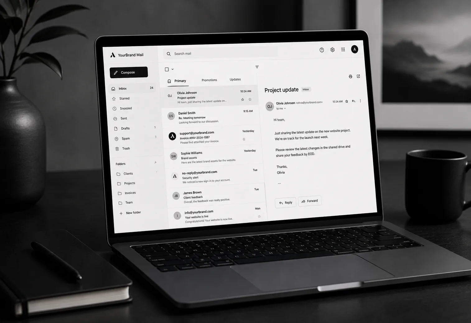 A branded inbox open on a laptop, one message read beside the list